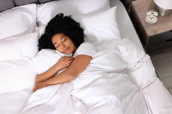 Woman sleeping with her clean down alternative comforter.